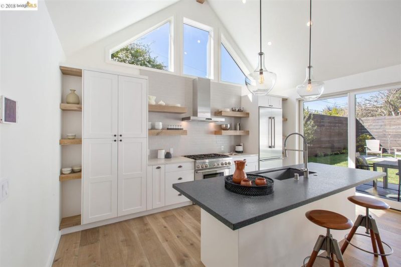 A kitchen with island and vaulted ceiling