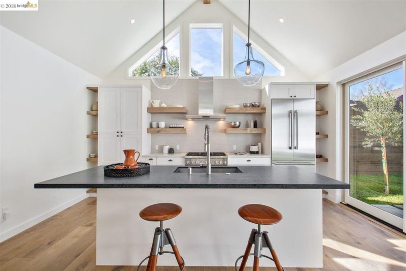 White kitchen with vaulted ceiling and island