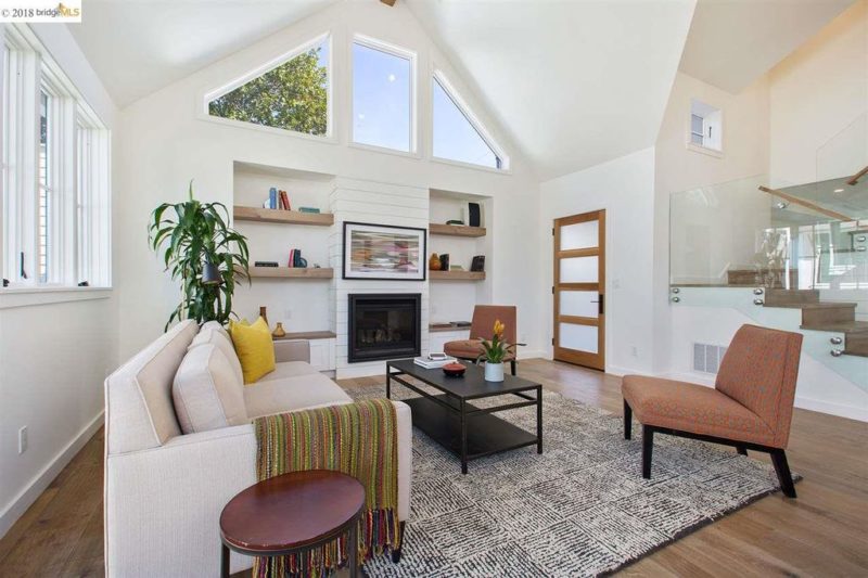 A living room with fireplace and built-in shelves on either side