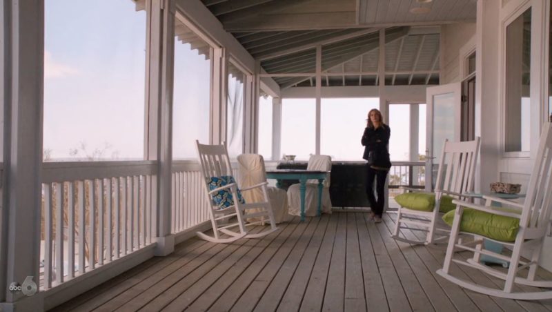 Emily on screened porch of beach house