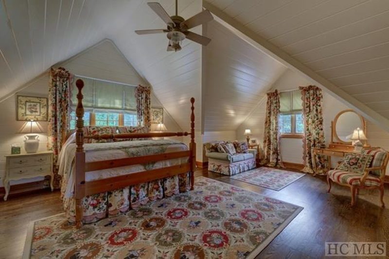 A bedroom with angled ceilings