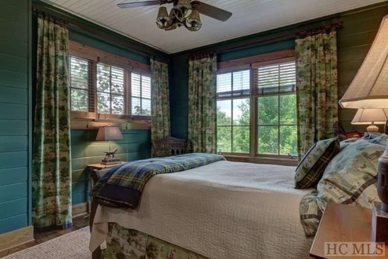 Bedroom with green walls and floral curtains