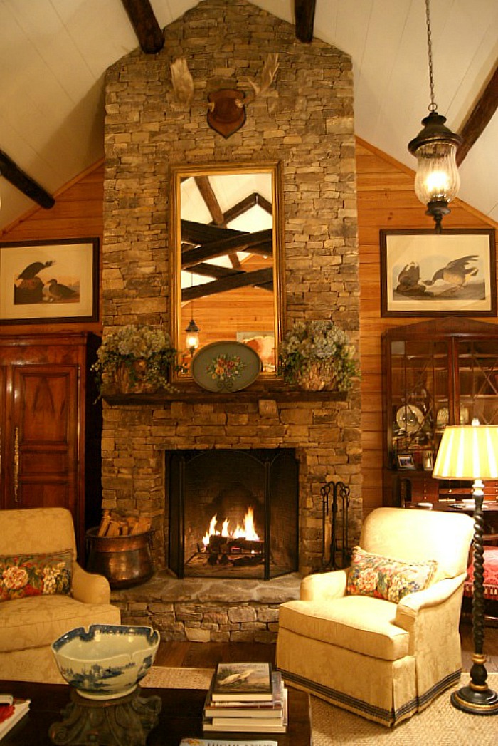 stone fireplace with wood walls mountain house