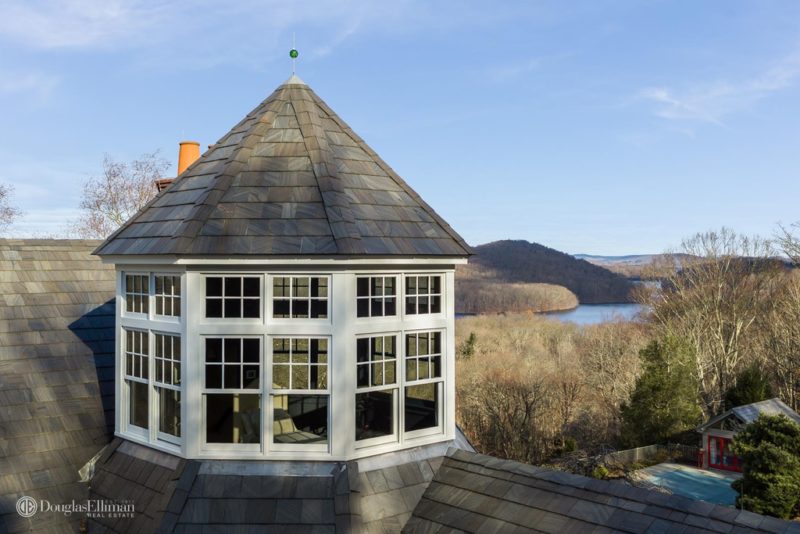 Exterior view of lookout tower at top of house and view of the water