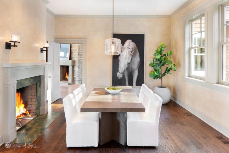 Dining room table and chairs with large photo of white horse on the wall