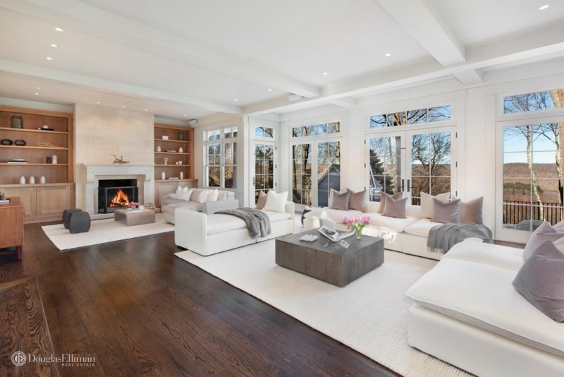 A living room filled with furniture and large windows