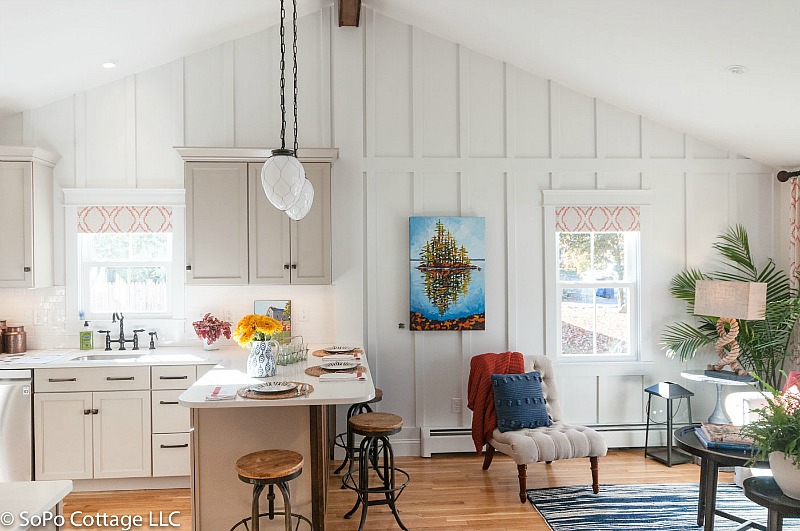 Cottage living room and kitchen with board-and-batten walls