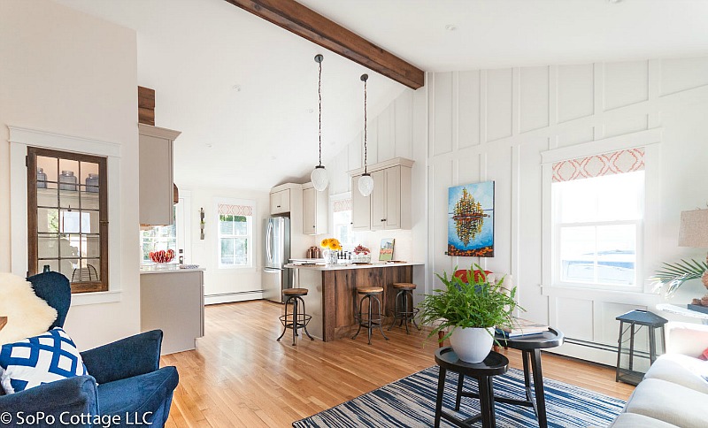 Cottage living room and kitchen after remodel with board-and-batten walls