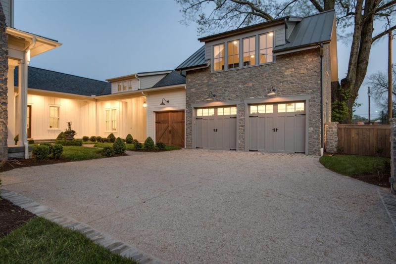 Exterior of stone two-car garage attached to farmhouse