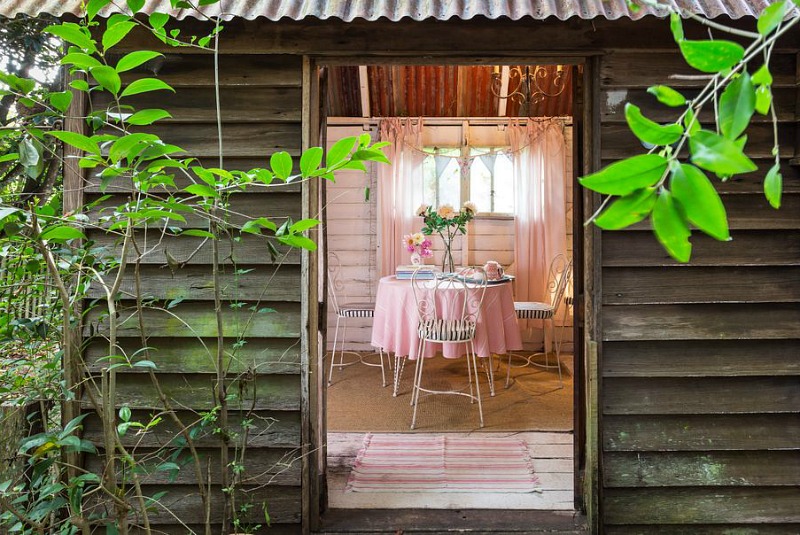 Small round table with pink tablcloth and metal chairs