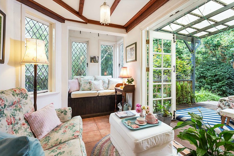 Room with window seat and leaded glass windows that opens to back deck