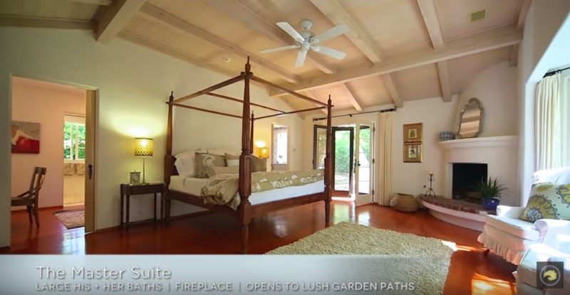 A bedroom with four-poster bed and beamed ceiling