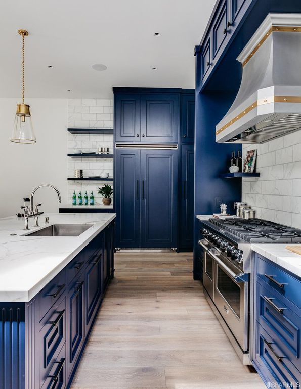 Kitchen with blue cabinets and large stainless range