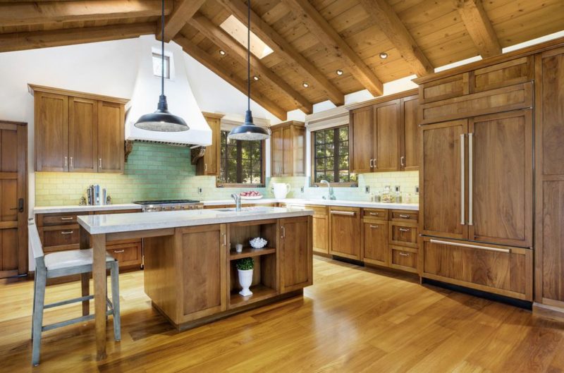 A large kitchen with stainless steel appliances and wooden cabinets