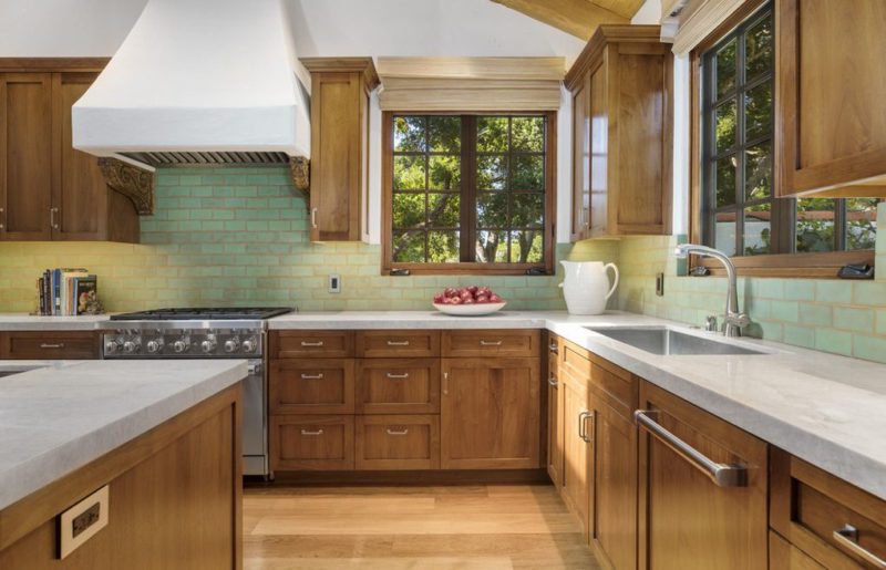 A large kitchen with stainless steel appliances and wooden cabinets