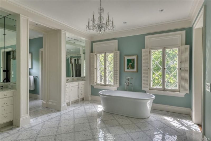 Large bathroom with freestanding tub and chandelier