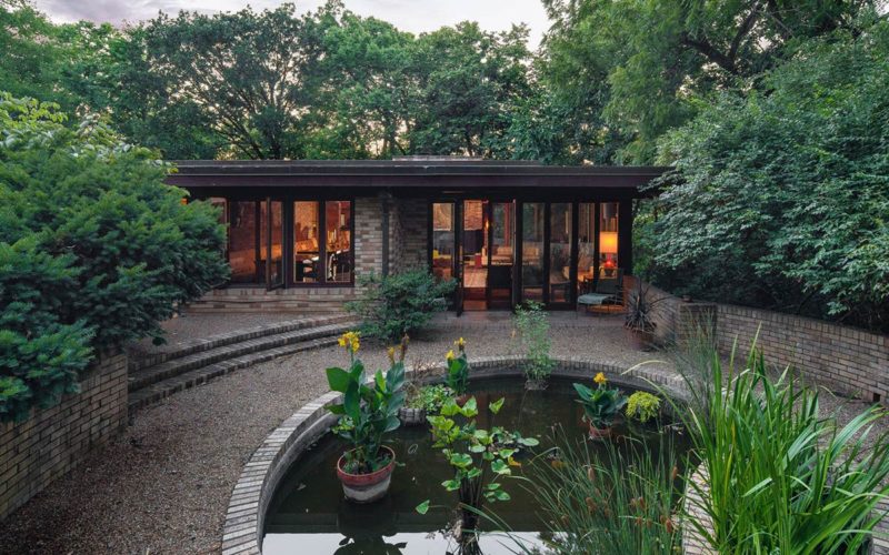 Patio and koi pond outside house