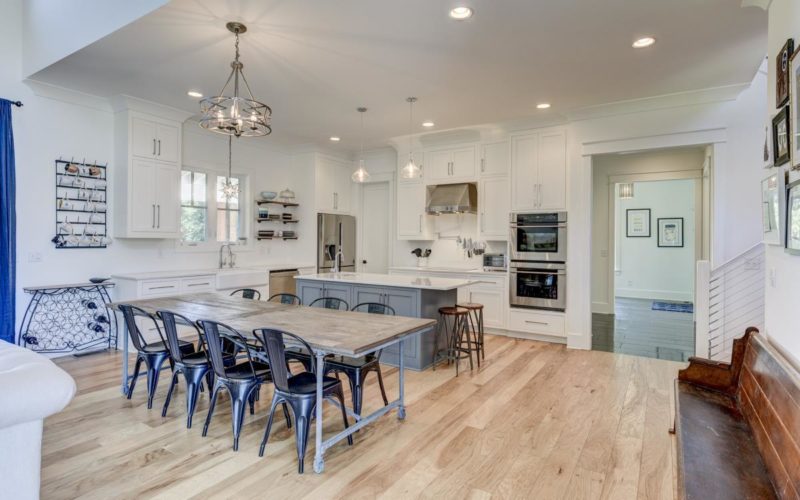 A kitchen with a wood table and metal chairs