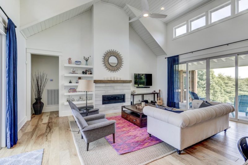 A living room with vaulted ceiling and fireplace