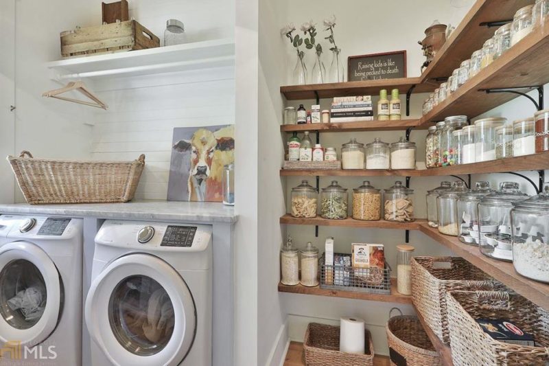 Laundry room with washer and storage shelving