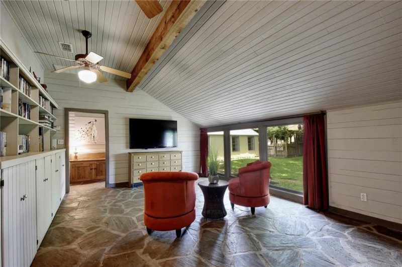 Large room with two chairs and TV