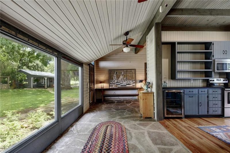 Walkway with large windows and flagstone floor