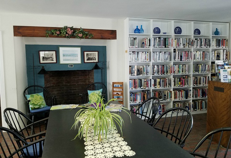 Inside Beach Haven Public Library with bookshelves and fireplace