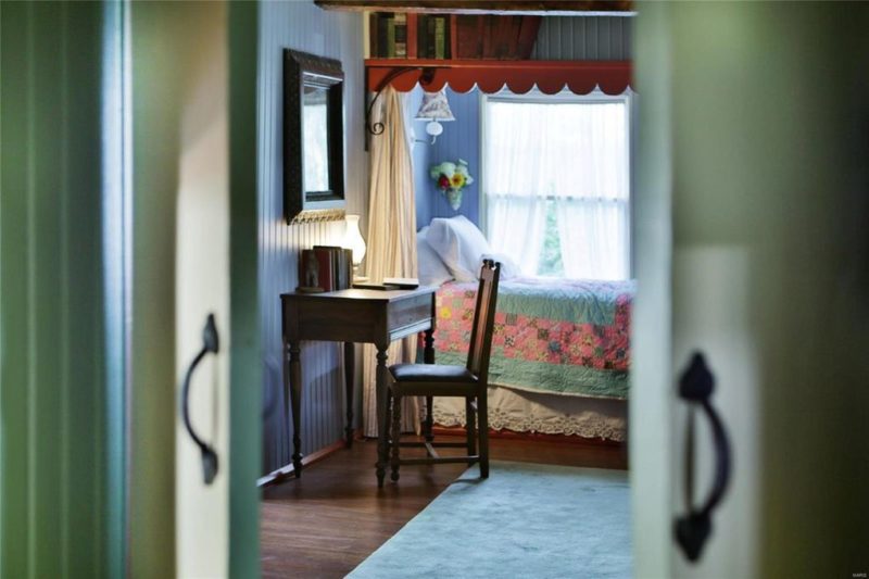 Desk and chair beside bed