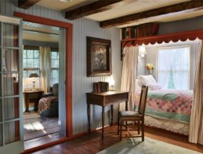 Small desk and chair beside built-in bed