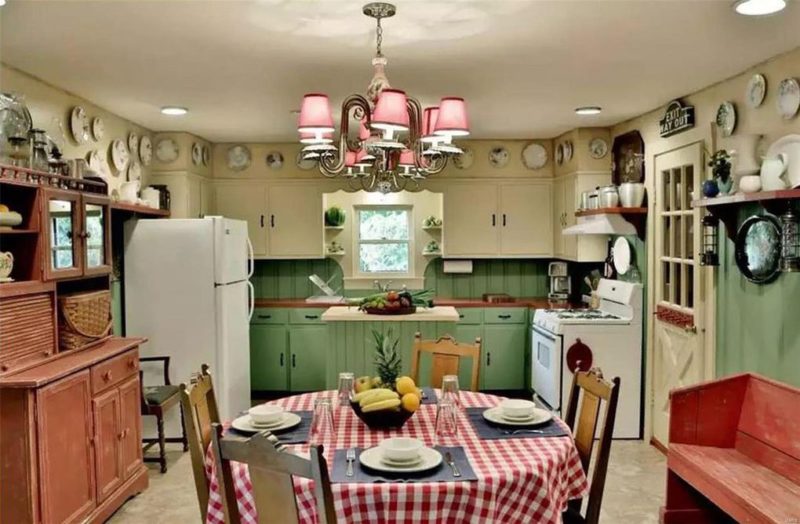 Cottage kitchen with green lowers and white upper cabinets, round table and chairs