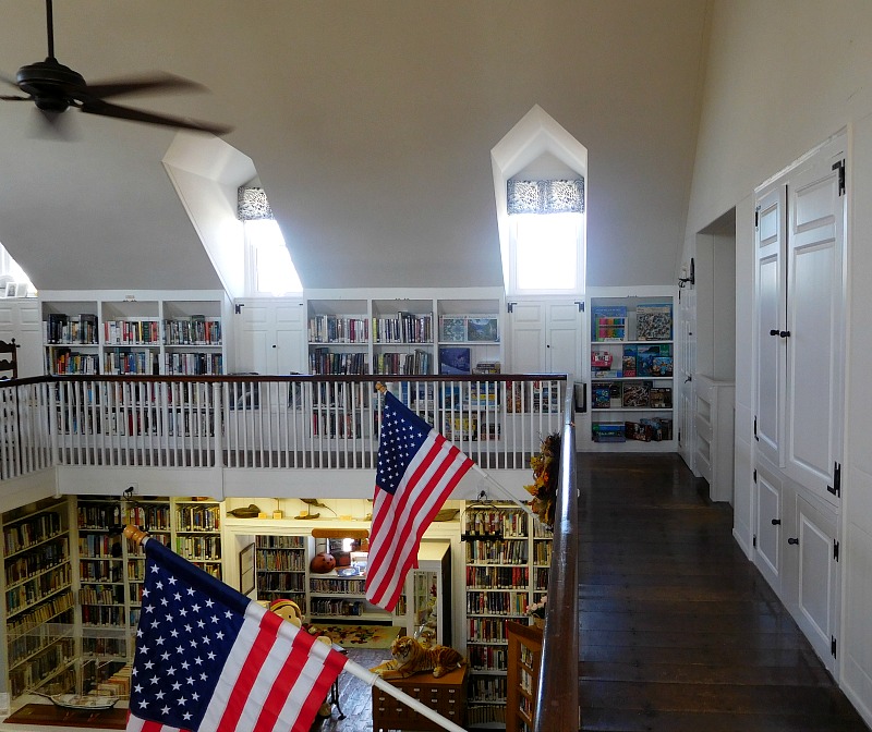 Inside Beach Haven Public Library with bookshelves on second floor