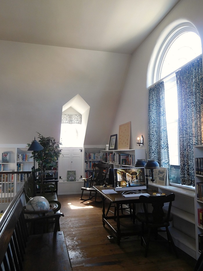 Inside Beach Haven Public Library with bookshelves on second floor