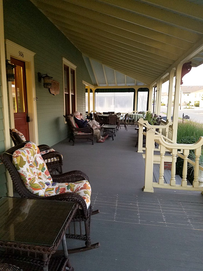 Large wraparound front porch with chairs 