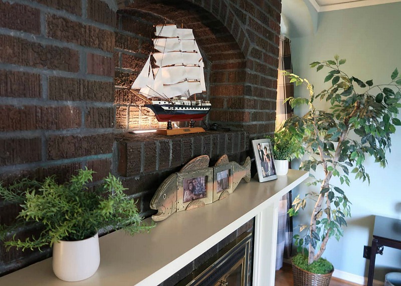 Closeup of fireplace mantel and model ship