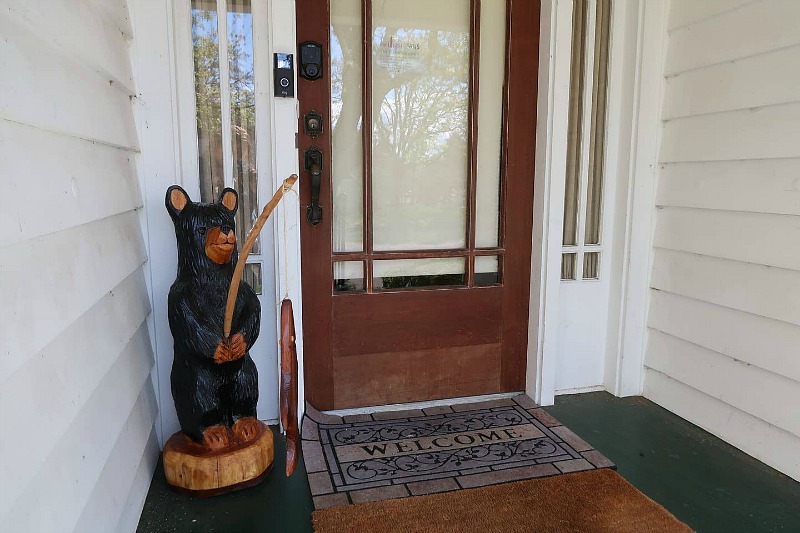 Front door with bear statue fishing