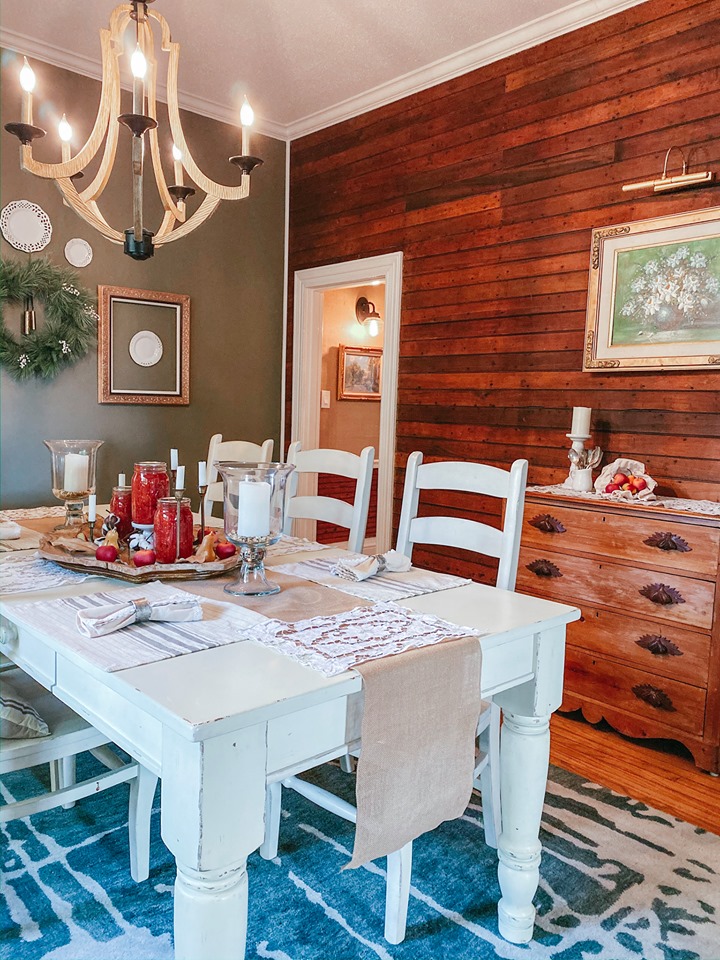 A dining room table with original shiplap walls