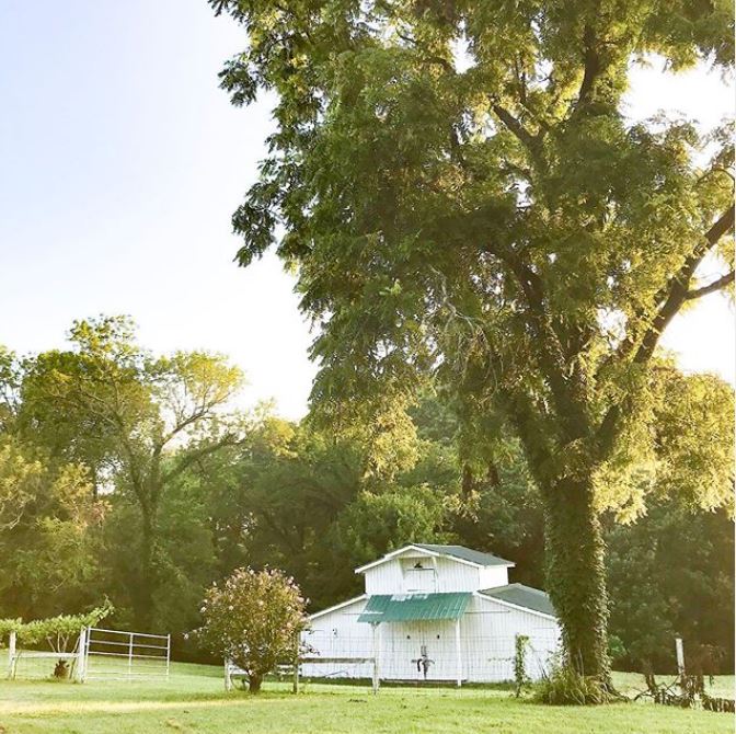 White barn with green roof