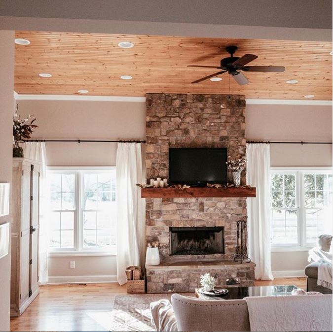 A living room filled with furniture and a stone fire place