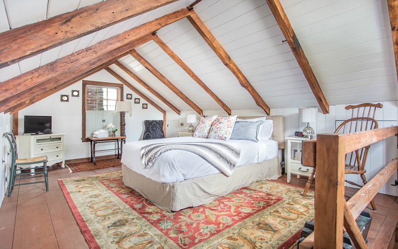 Upstairs cottage bedroom with vaulted beamed ceiling