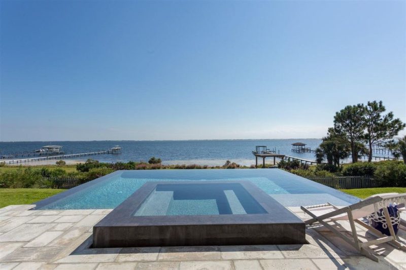 Infinity pool behind beach house