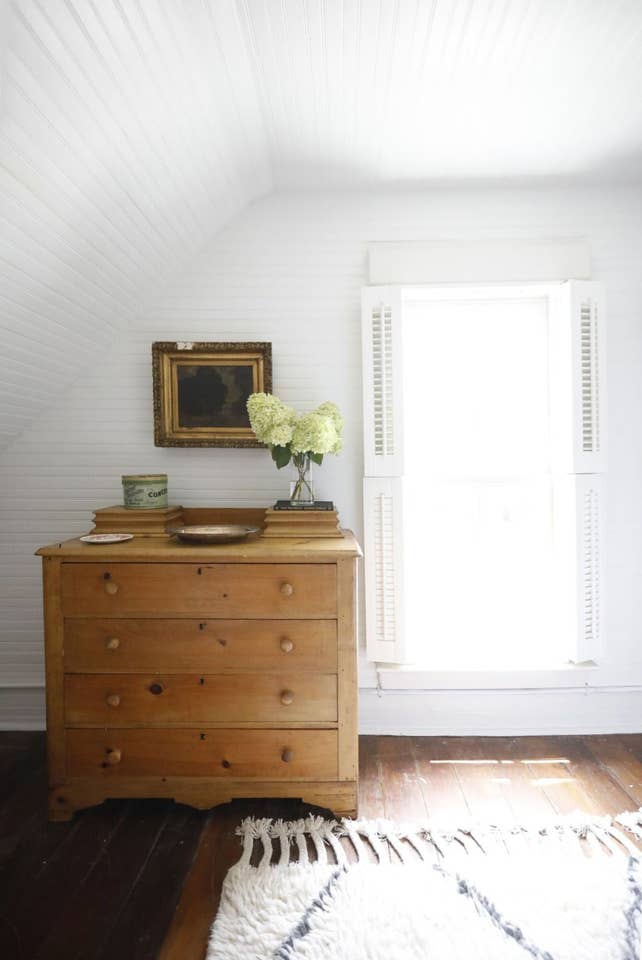 Bedroom dresser beside window