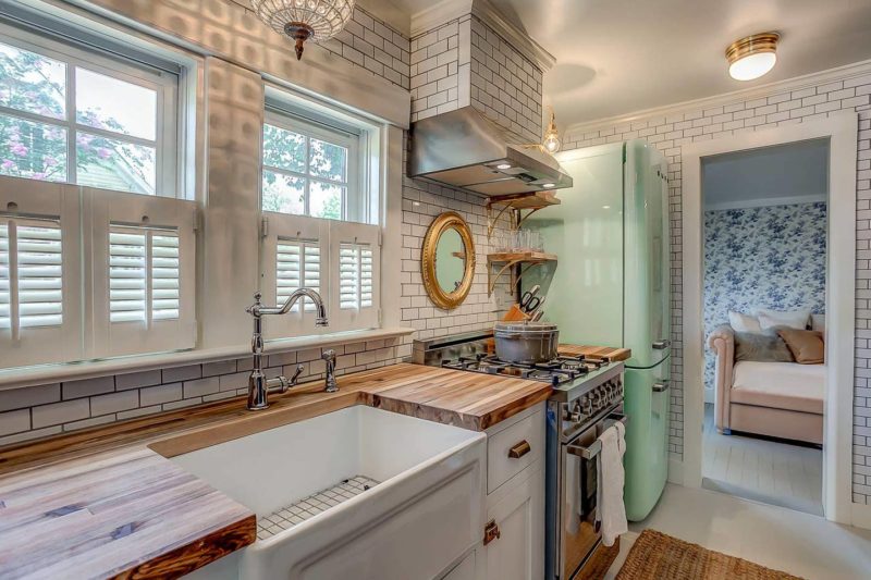 Cottage kitchen with retro pastel green Smeg fridge