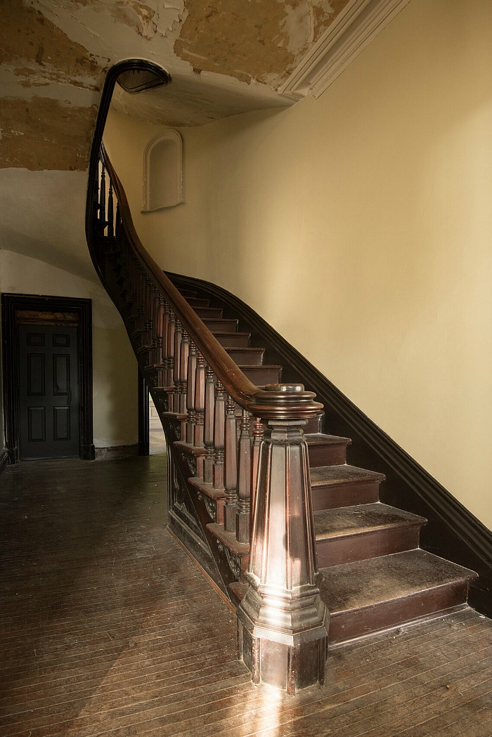 Dark wood staircase in entry hall