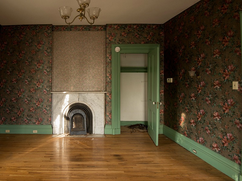 Wallpapered bedroom with fireplace