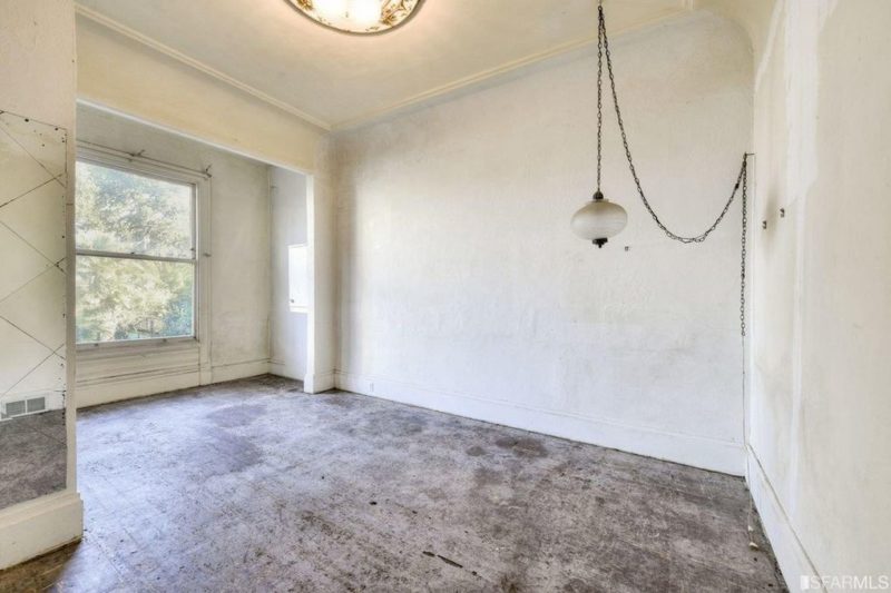 Empty bedroom with hanging light fixture