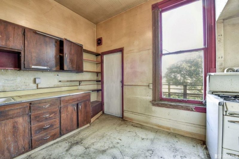 Empty kitchen with door to deck