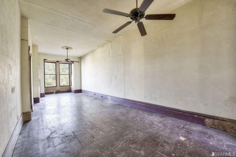 A large empty room with ceiling fan