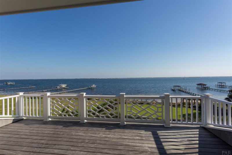 Deck with railing overlooking the water