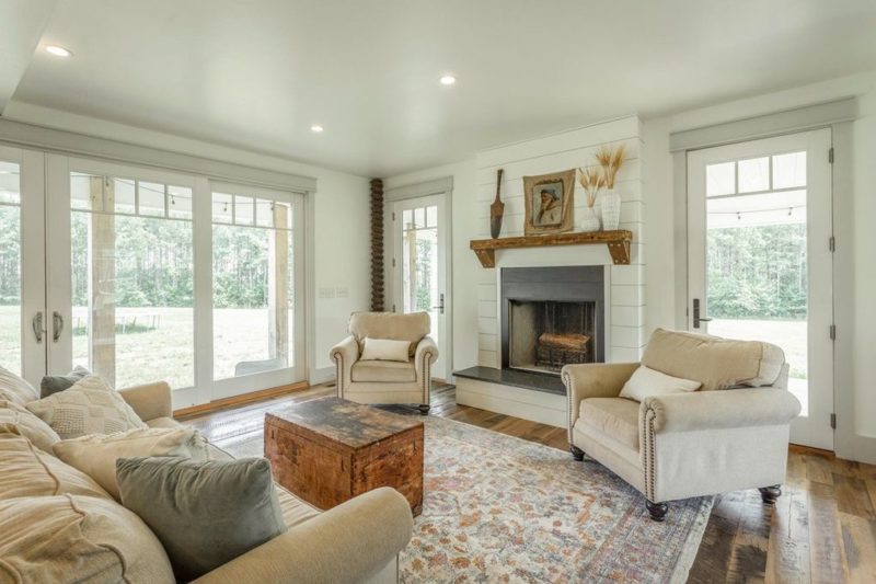 A view of a living room filled with furniture and a fire place