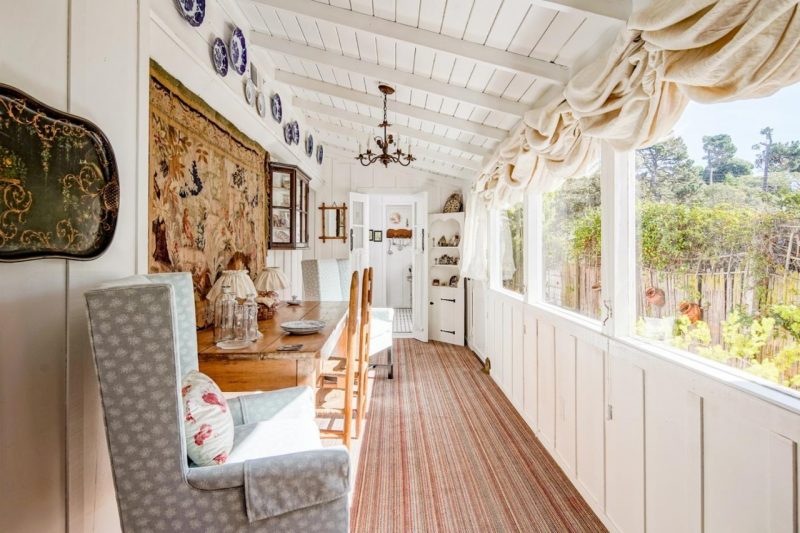 long room lined with windows in cottage